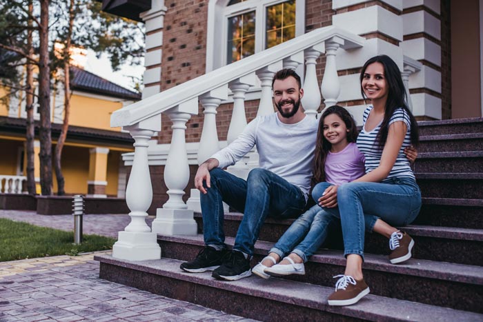 family in front of the house